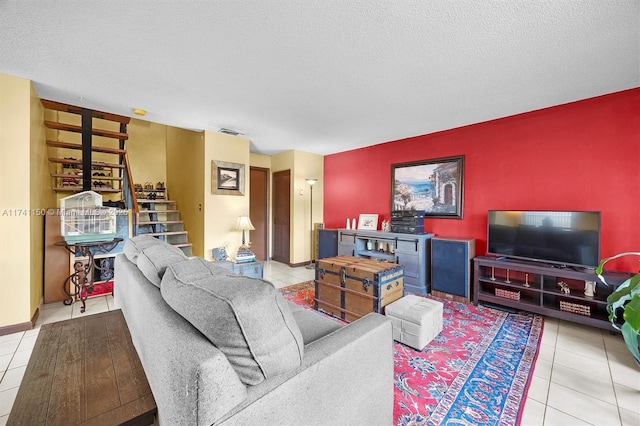 living room featuring a textured ceiling and light tile patterned floors