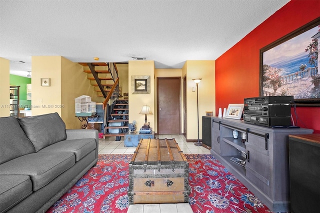 living room featuring light tile patterned floors and a textured ceiling