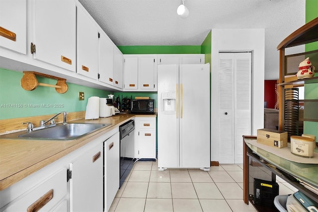 kitchen with light tile patterned flooring, sink, white cabinetry, a textured ceiling, and black appliances