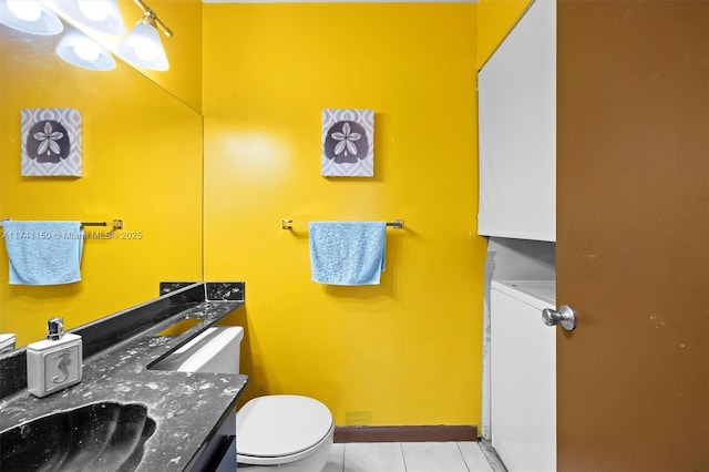 bathroom featuring tile patterned flooring, vanity, and toilet