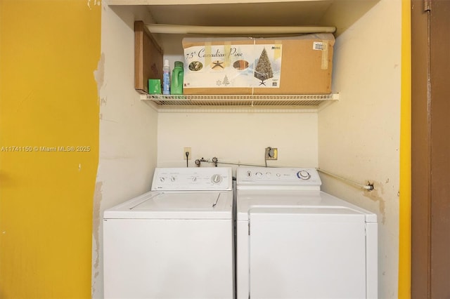 washroom with washing machine and clothes dryer