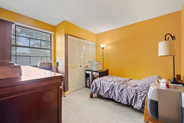 carpeted bedroom featuring a textured ceiling and a closet