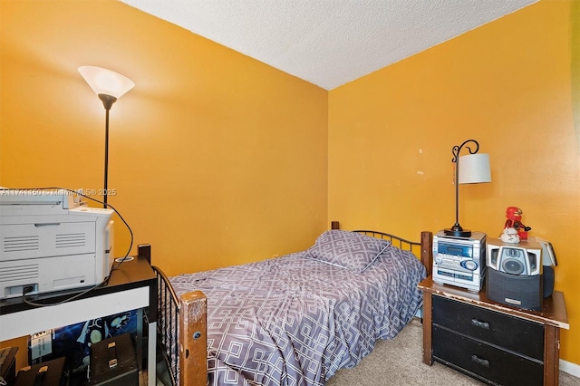 bedroom with carpet floors and a textured ceiling