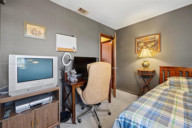 carpeted bedroom with a textured ceiling