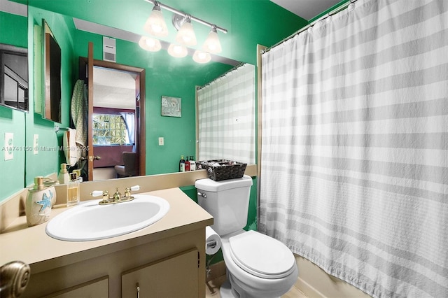 full bathroom with vanity, shower / bath combination with curtain, and toilet