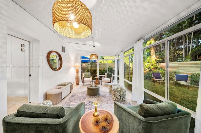 sunroom featuring vaulted ceiling