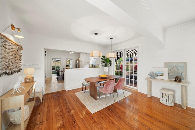 dining room featuring hardwood / wood-style floors, ornamental molding, and french doors