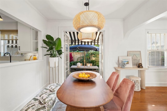 dining room featuring hardwood / wood-style flooring and ornamental molding