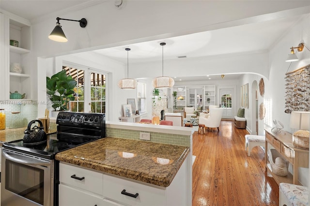 kitchen featuring white cabinetry, electric range, ornamental molding, and decorative light fixtures