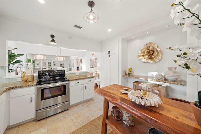 kitchen featuring white cabinetry, light stone counters, decorative light fixtures, light tile patterned floors, and electric stove