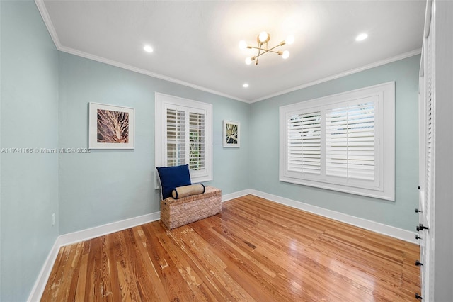 unfurnished room featuring crown molding, a notable chandelier, and light hardwood / wood-style flooring