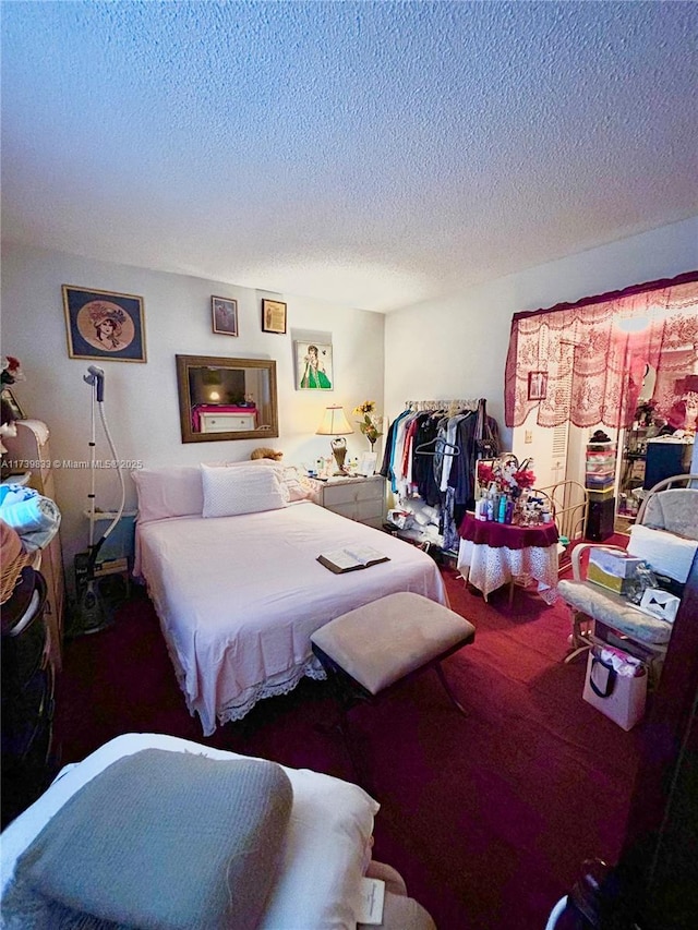 carpeted bedroom featuring a textured ceiling