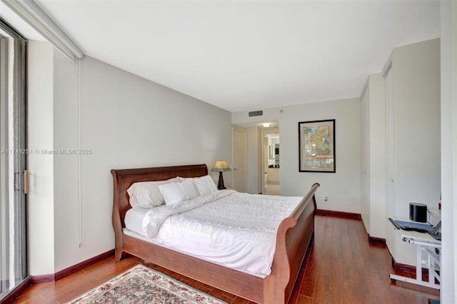 bedroom featuring dark hardwood / wood-style flooring