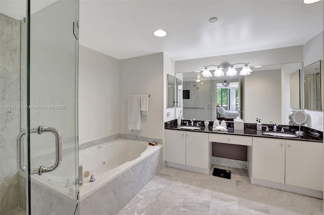 bathroom featuring vanity and independent shower and bath