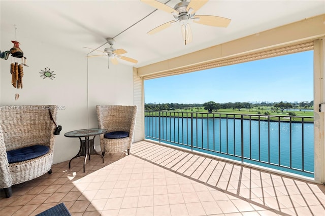 interior space with a water view and ceiling fan