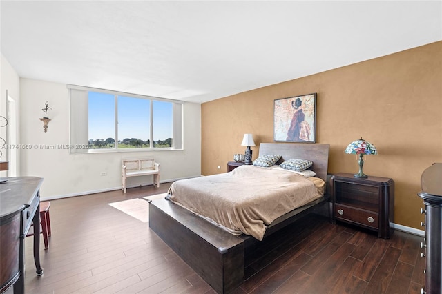 bedroom with dark wood-type flooring