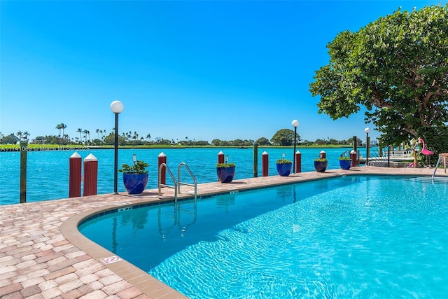 view of pool featuring a water view