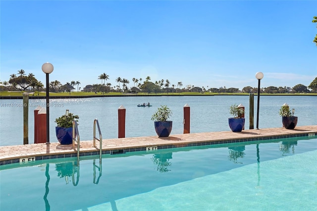 view of pool with a water view