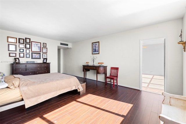 bedroom with dark wood-type flooring