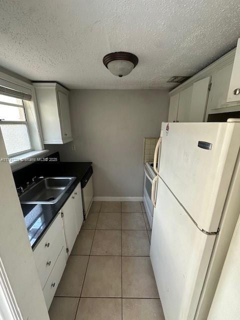 8600 SW 109th Ave Unit 4-216, Miami, FL 33173 - kitchen with white appliances, a sink, white cabinetry, baseboards, and a textured ceiling