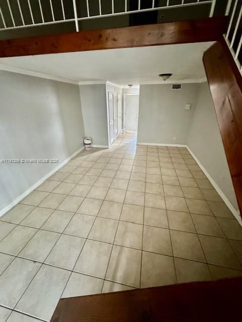 8600 SW 109th Ave Unit 4-216, Miami, FL 33173 - spare room featuring ornamental molding, light tile patterned floors, and baseboards