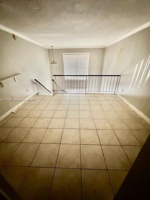 8600 SW 109th Ave Unit 4-216, Miami, FL 33173 - tiled empty room with crown molding, a textured ceiling, and baseboards