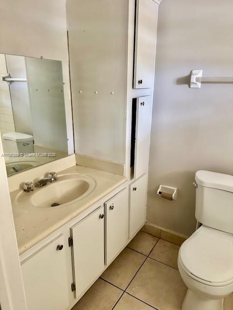 8600 SW 109th Ave Unit 4-216, Miami, FL 33173 - bathroom with toilet, vanity, tile patterned floors, and baseboards