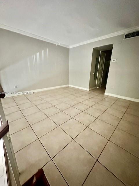 8600 SW 109th Ave Unit 4-216, Miami, FL 33173 - unfurnished room with light tile patterned floors, crown molding, and baseboards