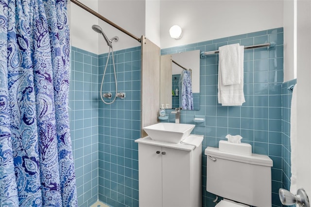 bathroom with vanity, toilet, curtained shower, and tile walls