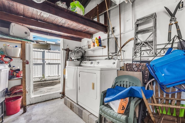 laundry area with a healthy amount of sunlight, wooden ceiling, and washer and clothes dryer