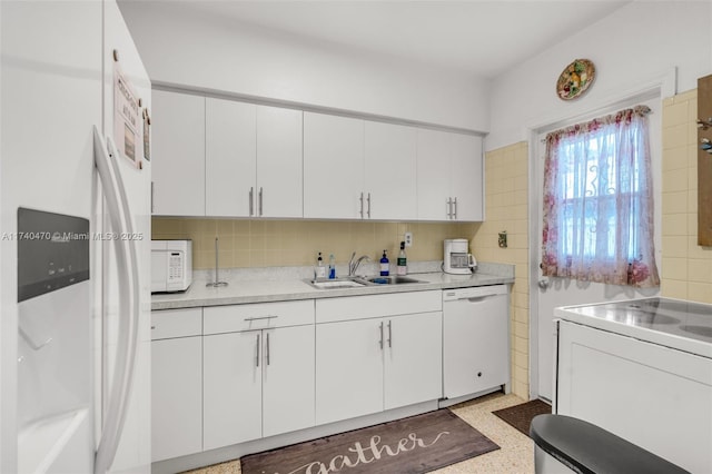 kitchen with white cabinetry, sink, white appliances, and decorative backsplash