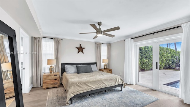 bedroom featuring ornamental molding, light hardwood / wood-style flooring, access to exterior, and french doors