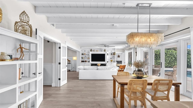 dining space featuring built in shelves, wood ceiling, light wood-type flooring, beam ceiling, and ceiling fan with notable chandelier