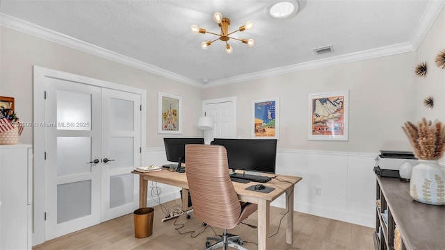 office area with ornamental molding, a textured ceiling, and light wood-type flooring