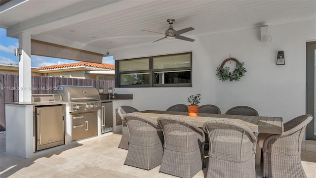 view of patio / terrace featuring area for grilling, sink, ceiling fan, and exterior kitchen