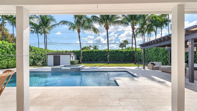 view of pool featuring an in ground hot tub, an outdoor living space, a patio area, and a shed