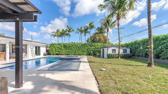 view of swimming pool with an outbuilding, a lawn, and a patio