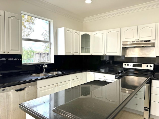 kitchen featuring stainless steel appliances, dark countertops, glass insert cabinets, a sink, and under cabinet range hood