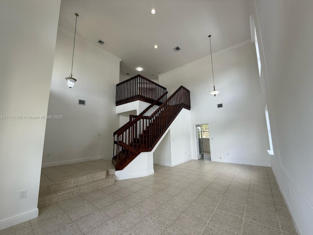 interior space featuring recessed lighting, visible vents, stairway, a high ceiling, and baseboards