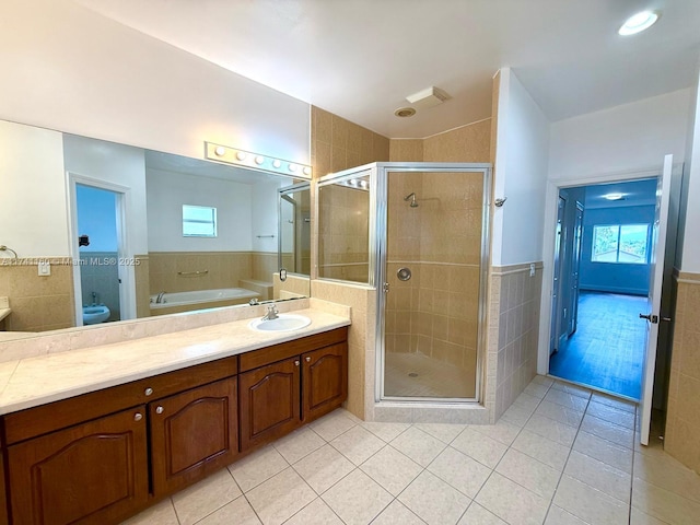 full bath featuring tile patterned flooring, a shower stall, tile walls, and toilet