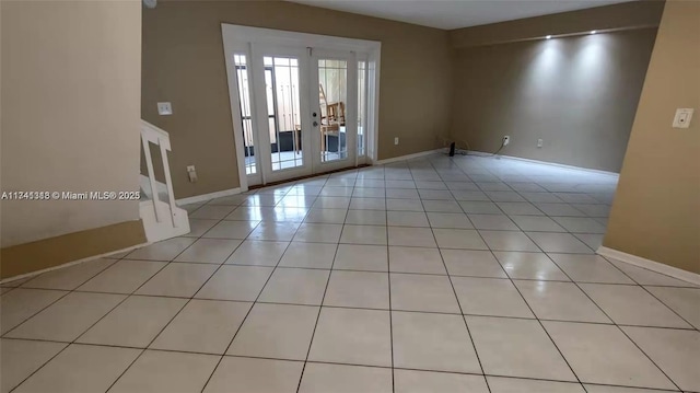 tiled spare room with french doors