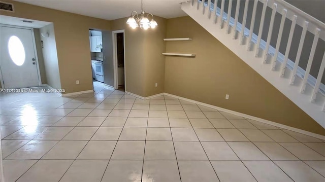 foyer entrance with light tile patterned floors and a notable chandelier