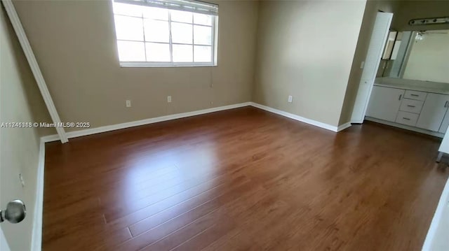 unfurnished bedroom featuring dark hardwood / wood-style flooring