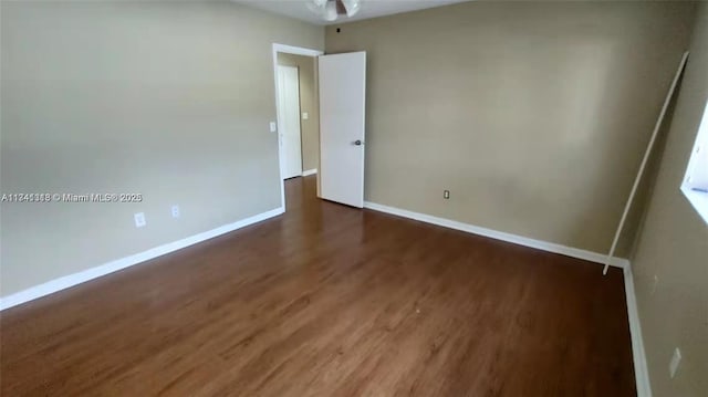 unfurnished room featuring dark hardwood / wood-style flooring