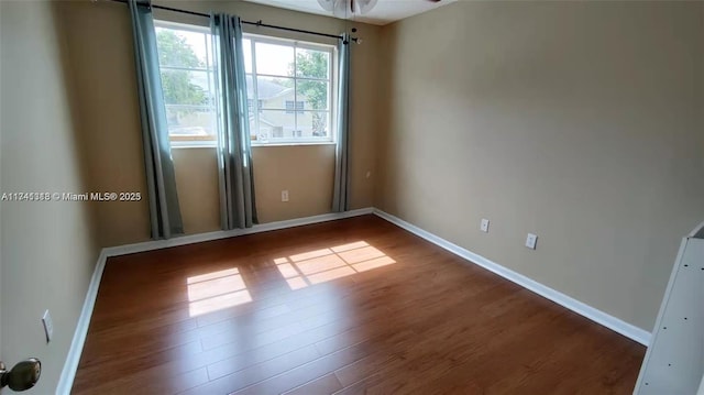 unfurnished room with wood-type flooring