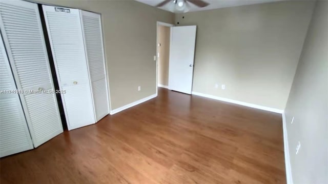 unfurnished bedroom with hardwood / wood-style floors, ceiling fan, and a closet