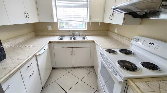 kitchen featuring sink, white appliances, tile countertops, and white cabinets