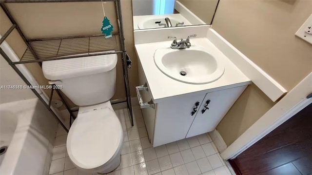 bathroom with vanity, tile patterned floors, and toilet