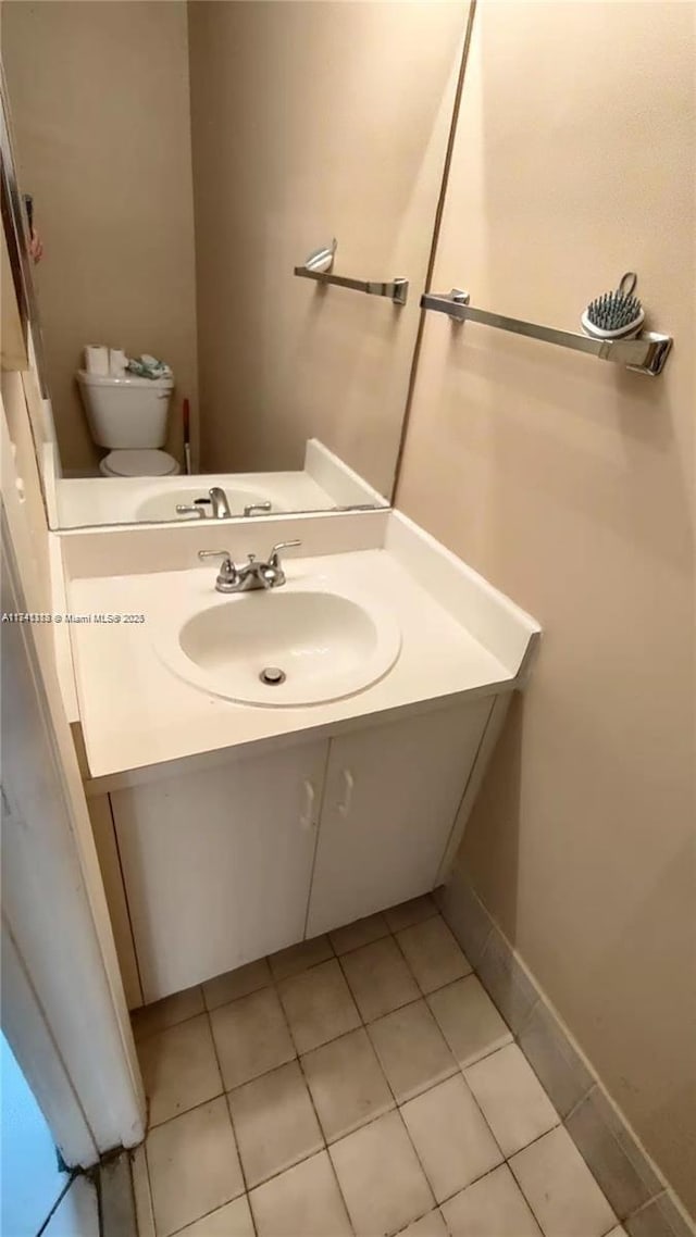 bathroom featuring tile patterned floors, toilet, and vanity