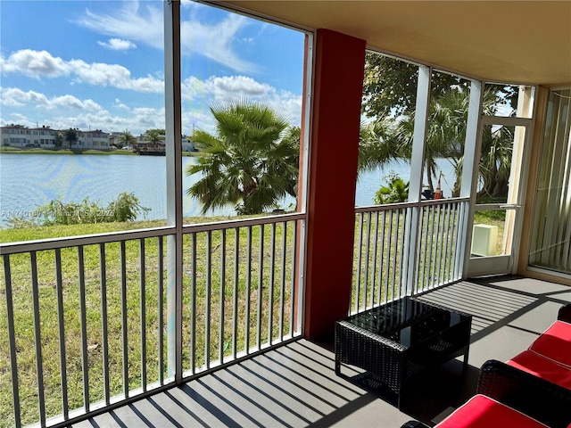 unfurnished sunroom featuring a water view